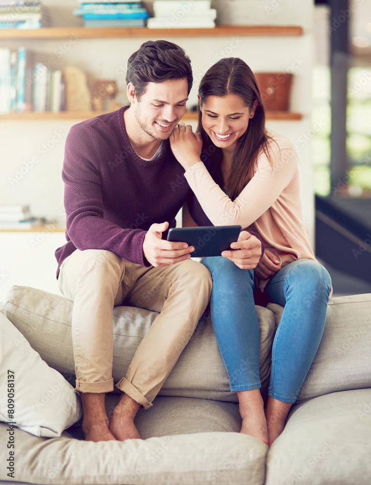 Smile, couple and relax on sofa with tablet for social media, news or streaming video together. Digital technology, man and woman in living room for online shopping or reading blog on app in home Smile, couple and relax on sofa with tablet for social media, news or streaming video together. Digital technology, man and woman in living room for online shopping or reading blog on app in home