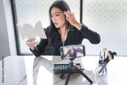 Beauty influencer Asian girl Using Social Media for live streaming on Smartphone online audience like and subscribe to her channel. Like, Follower, Comment