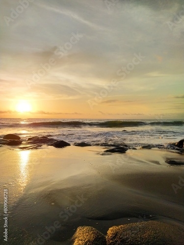 Yellow-orange sunset and sunrise on the ocean shore  Bali island. Epic sunrise  sandy beach. Landscape of Indonesia