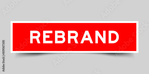 Square sticker label with word rebrand in red color on gray background