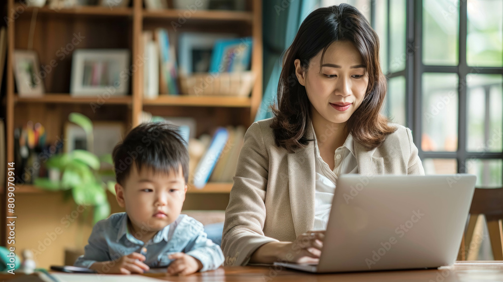 Asian Businesswoman Mom Working On Her Laptop In Her Home With Her Son Asian Businesswoman Mom Working On Her Laptop In Her Home With Her Son