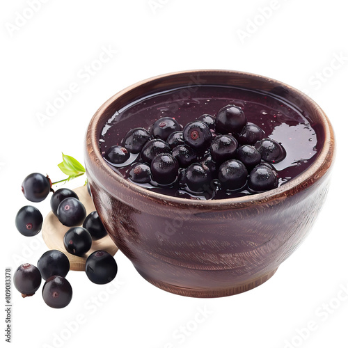 Black currant jam in a wooden bowl on a white background. Isolated. photo