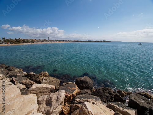 Photo on the surface of crashed waves on the beach of the coast. Tropical surf on the beach. waves on the golden sand of the beach. Fantastic sea view with calm sea water waves and sunlight