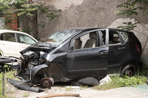 Crashed broken down car in automobile junk scrap yard