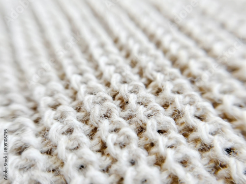 Texture of knitted woolen fabric close up photo