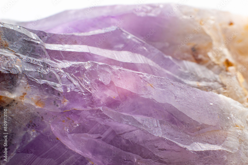 Obraz premium Purple and red amethyst crystal natural point cluster, purple quartz crystal amethyst with iron and hematite inclusions isolated on a white surface background close up macro