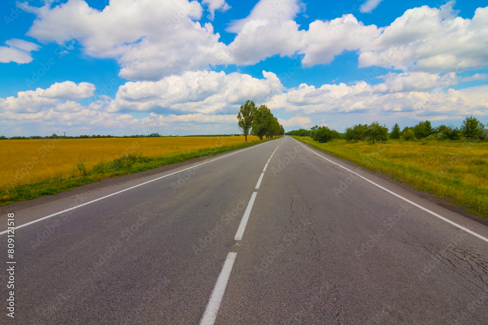 long asphat road under a cloudy sky, summer transportation scene long asphat road under a cloudy sky, summer transportation scene
