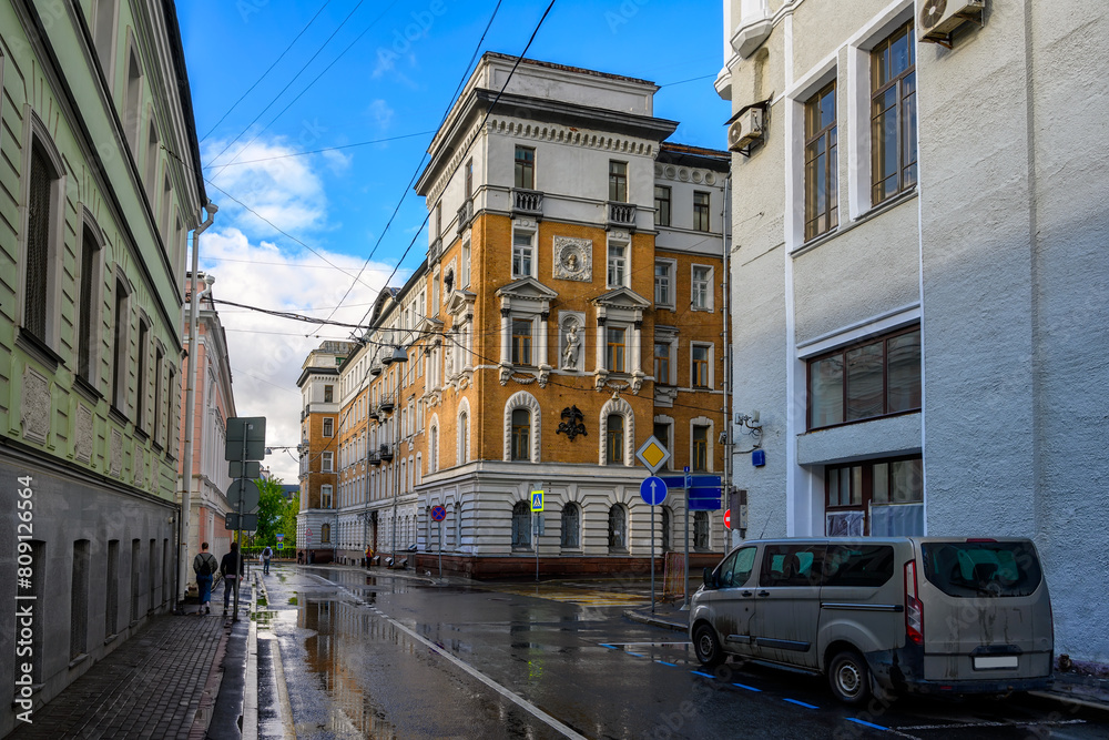 Old narrow street in center of Moscow in Russia. Cozy cityscape of Moscow. Architecture and landmarks of Moscow.