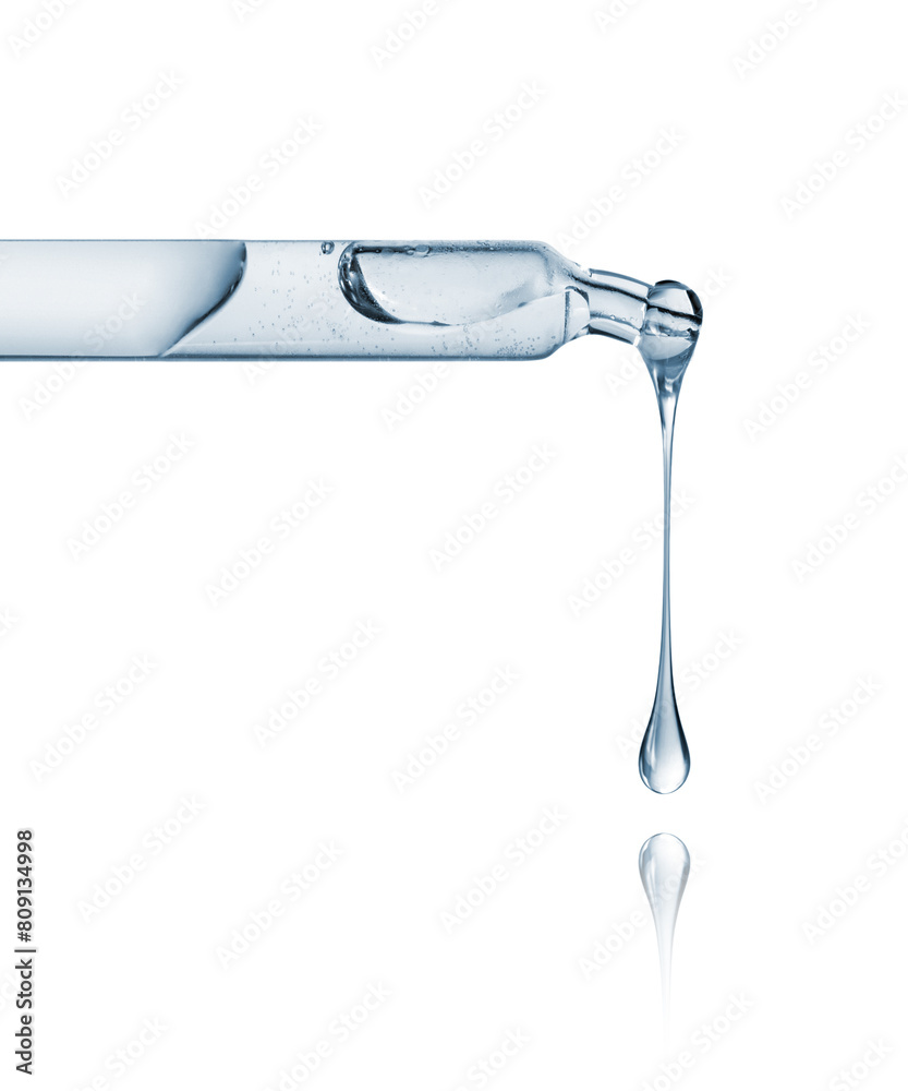 Cosmetic or medical pipette with dripping drops close-up on a white background Cosmetic or medical pipette with dripping drops close-up on a white background