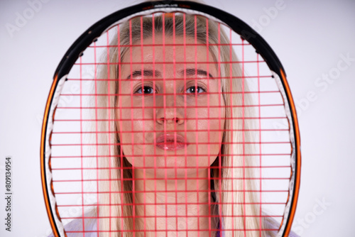 Sporty blonde woman with tennis racquet