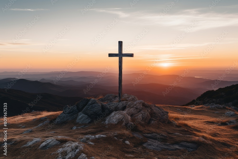 Wooden cross on rocky mountain at sunset Wooden cross on rocky mountain at sunset