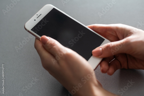hands holding pressing smartphone buttons