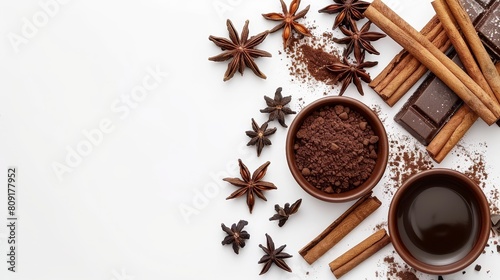  A cup of coffee on a white background, surrounded by cinnamon sticks, star anise, and chocolate pieces