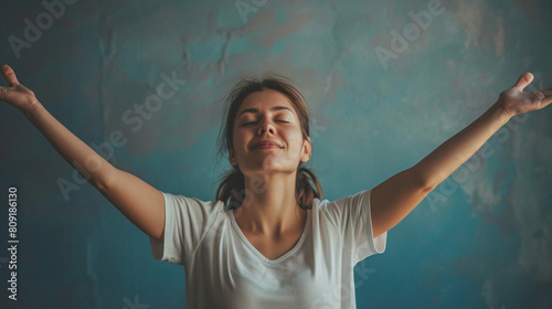 Portrait of determinated woman rising her arms up in the air in sign photo