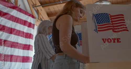Low Angle of a diverse group of voters voting at a polling station 