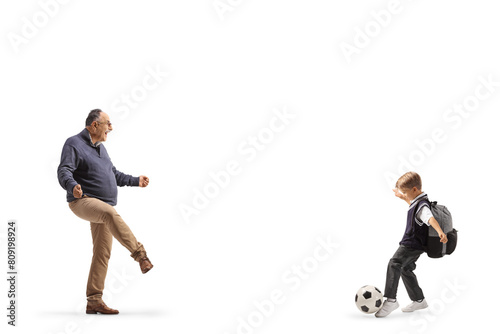 Mature man playing football with a schoolboy