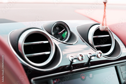Air deflector and climate control inside a luxury car. Close up of car interior details photo