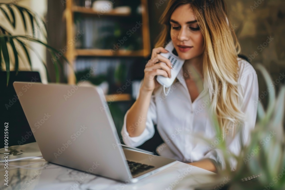 A woman talking on a phone while simultaneously using a laptop, A customer making a phone call to inquire about a product or service