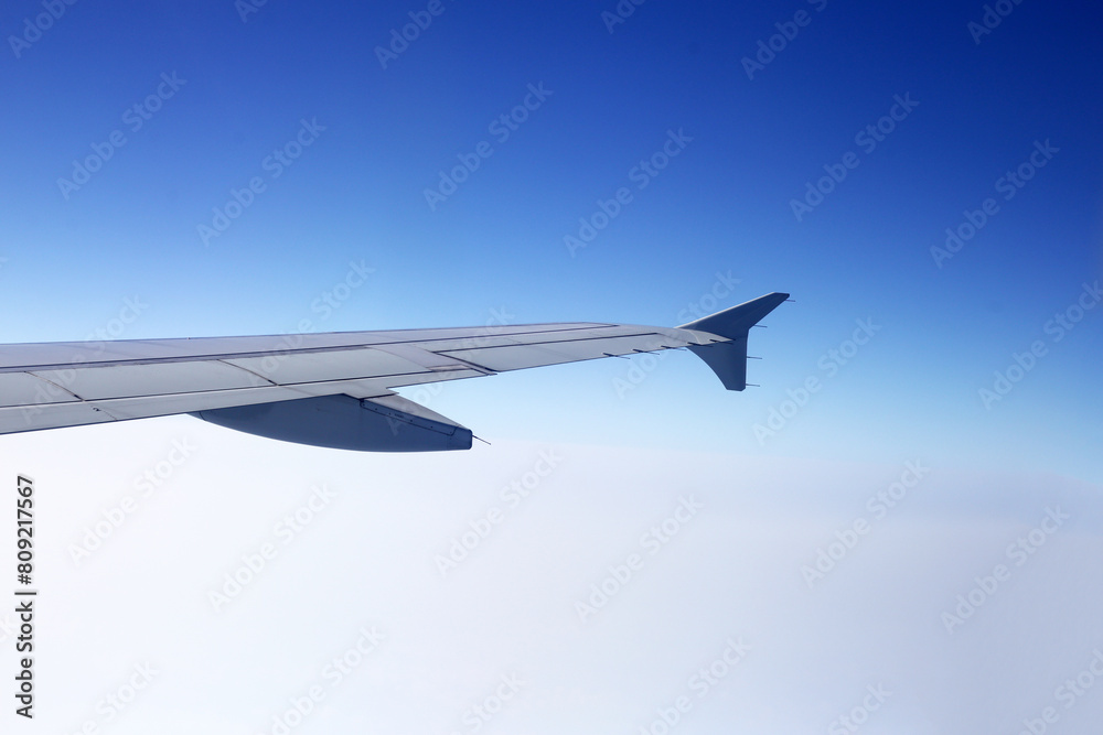 View of sky cloud and wing of airplane from window