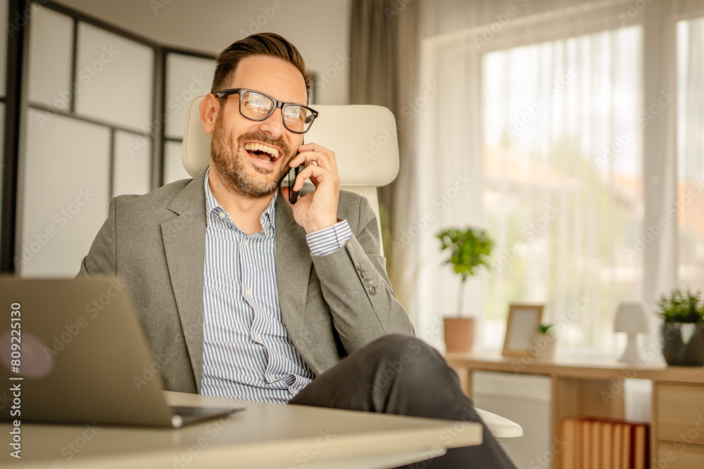 One men working in the office using technology talking on mobile phone One men working in the office using technology talking on mobile phone