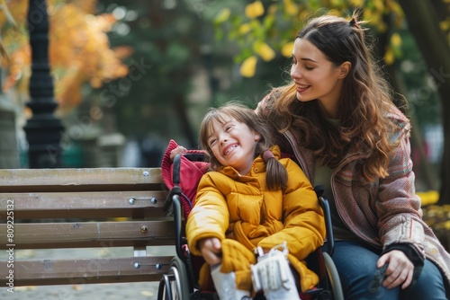 A woman in a wheelchair is sitting on a bench with a young girl
