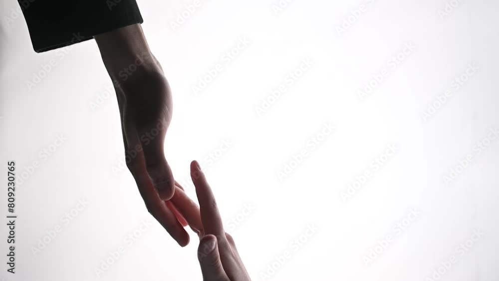 Female fingers stroking a male palm on a white background Female fingers stroking a male palm on a white background