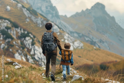 A man and child hike up a steep hill in the mountains, A father and son hiking in the mountains, exploring nature