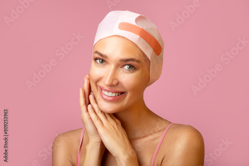 Wallpaper Mural Hair beauty. Beautiful woman using conditioner or hair mask with modern cap or towel, doing beauty routine, posing on pink studio background Torontodigital.ca