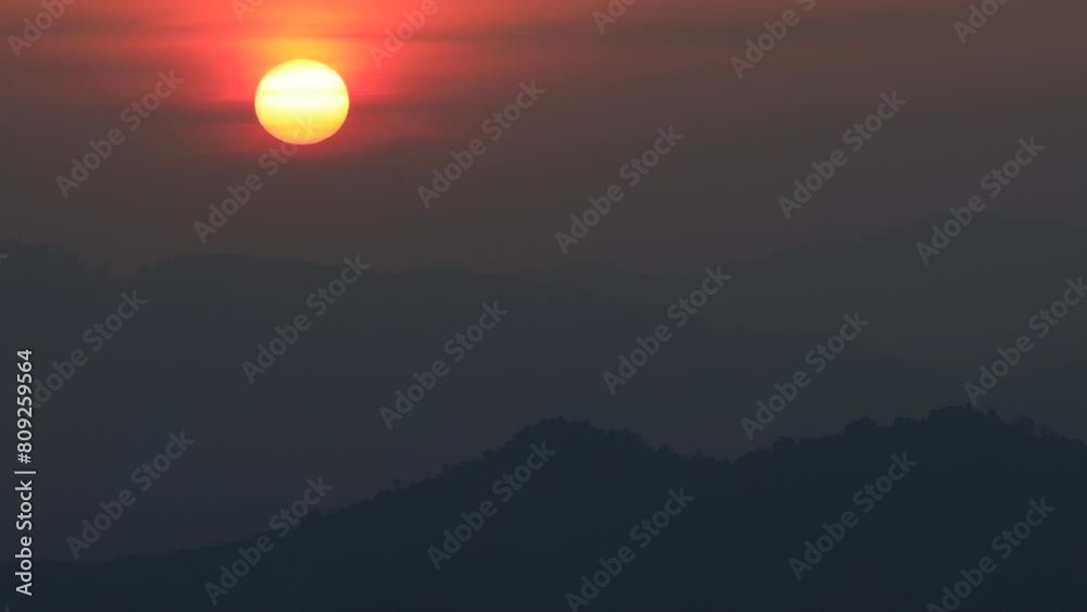 Evening high angle video background with the sun setting behind the horizon in the mountains by the sea. And surrounded by large trees, the fresh air of the wind blowing blurredly across the viewpoint Evening high angle video background with the sun setting behind the horizon in the mountains by the sea. And surrounded by large trees, the fresh air of the wind blowing blurredly across the viewpoint