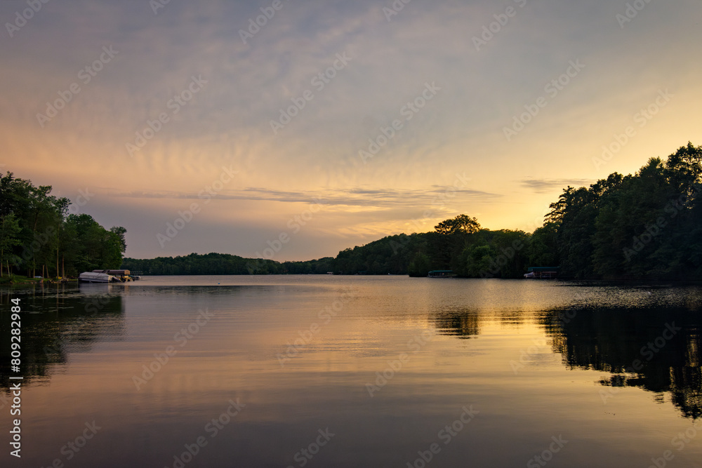 Fototapeta premium Looking onto a calm Wisconsin lake in the evening as the sun goes down.