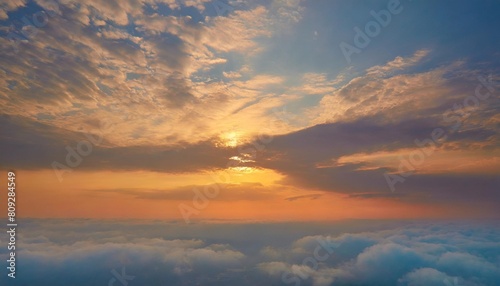 a serene and peaceful scene of the sun setting over a vast expanse of sky filled with fluffy clouds