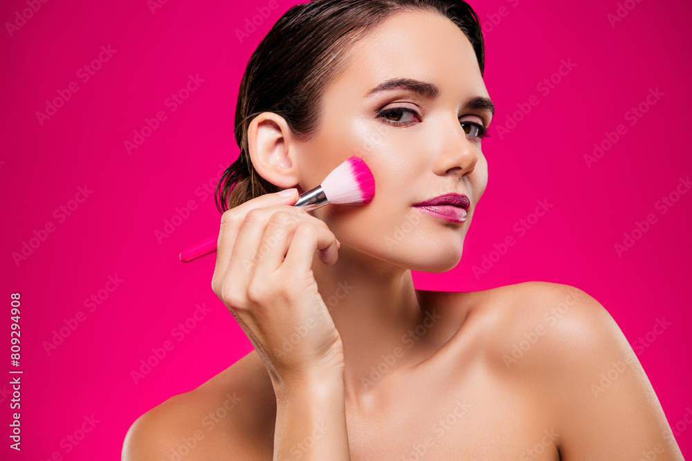 Photo portrait of attractive young woman apply brush face shoulders off isolated on pink color background Photo portrait of attractive young woman apply brush face shoulders off isolated on pink color background