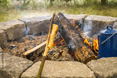 Bannock cooked over a fire inside a tipi photo