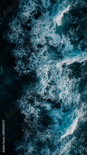 Aerial view of swirling sea foam in dark ocean waters