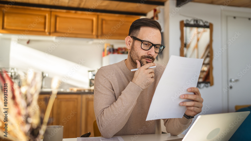 Adult man read and look document work at home paper work Adult man read and look document work at home paper work