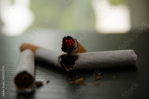 world no tobacco day 
cigarette lit on top of a broken cigarette 