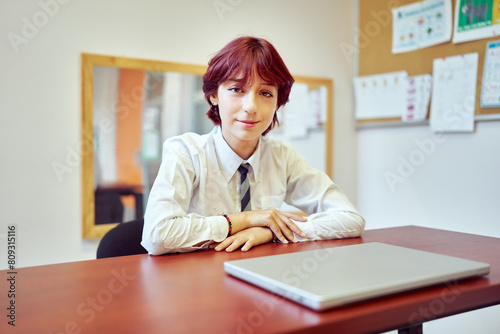 portrait latin American middle school student sitting in classroom smiling, success concept 