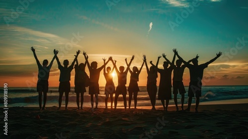 Backlit silhouette of Group of people partying on the beach at sunset or sunrise  They have their arms raised in celebration  aesthetic look