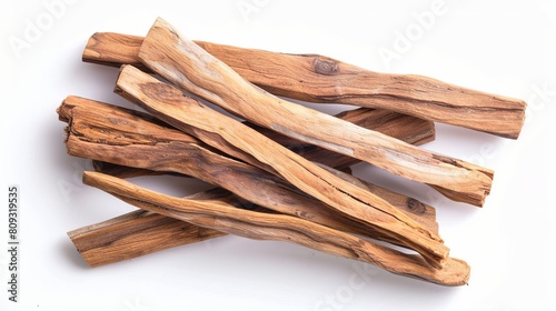 Isolated sandalwood sticks presented in a top view on a white background, emphasizing the natural texture and form of the wood