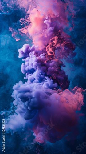 A cloud of blue and pink smoke billows and hovers in the air  creating a colorful and ethereal sight