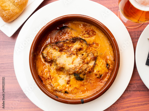 Delicious Greek moussaka from baked eggplant, tomato, minced lamb meat, cheese and bechamel sauce in earthenware dish