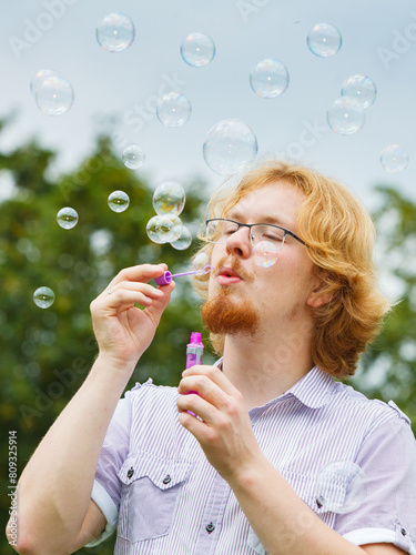 Man blowing soap bubbles  having fun