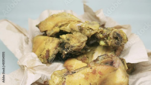 Ayam Ungkep Bumbu Kuning (yellow spiced fried chicken) ready to eat, homemade recipe on white background photo