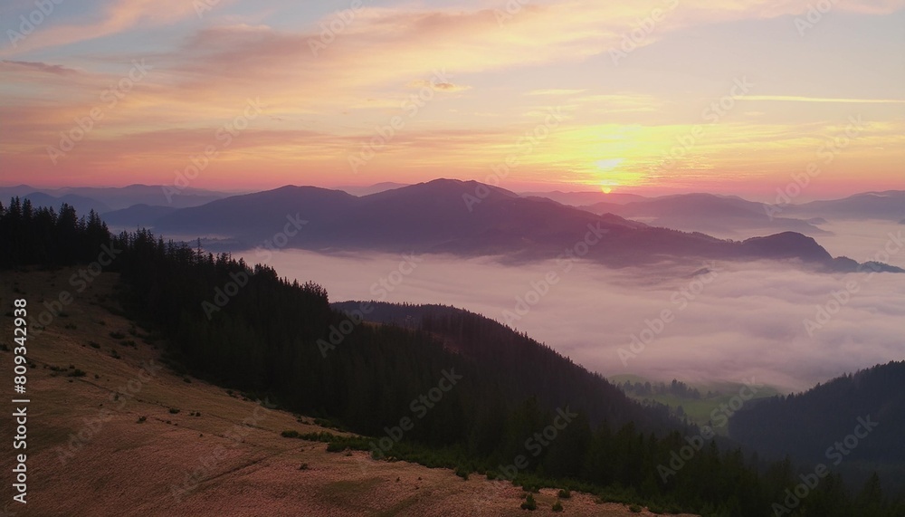 amazing panoramic landscape in the mountains at sunrise view of colorful sky and foggy hills covered by forest concept of the awakening wildlife