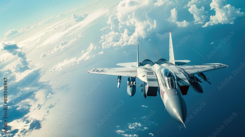 Fototapeta premium Fighter jet flying high above clouds with underwing missiles visible