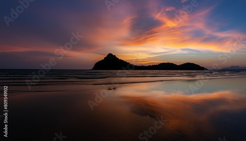 natural background of the colorful sky and beautiful water reflection during sunset at mae ramphueng beach prachuap khiri khan province in thailand