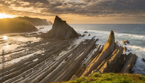 flysch rock formations and sea at sunset guipuzcoa spain photo