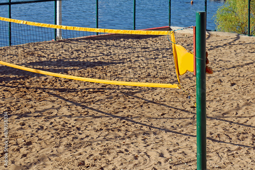 Net for leisure volleyball playing on a beach sand during summer © Tatty
