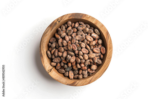 a wooden bowl filled with nuts on top of a white surface