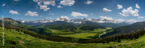 Breathtaking Panorama of Snow-capped US Mountains Amidst Vibrant Greenery and Bright Azure Sky